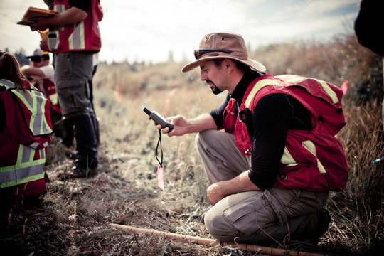 Researcher inputs data on a GPS unit