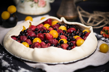 homemade puff pastry pie with cherry plums, blueberries and strawberries