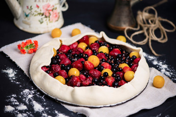 homemade puff pastry pie with cherry plums, blueberries and strawberries