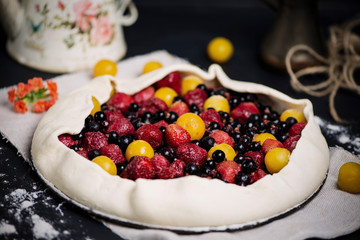 homemade puff pastry pie with cherry plums, blueberries and strawberries