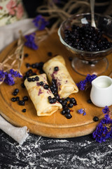 sweet pancakes with blueberry jam and berry jam in a glass vase