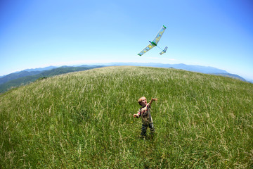 Young boy flies a toy glider along the Appalachian Trail on the summit of Max Patch Bald west of Asheville, NC