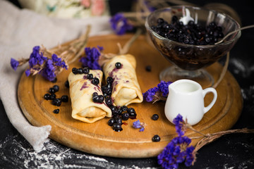 Obraz na płótnie Canvas sweet pancakes with blueberry jam and berry jam in a glass vase