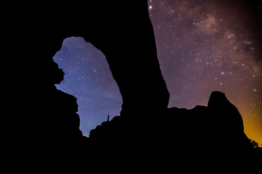 Whit Richardson stands below North Window Arch, Arches National Park, Moab, Utah.