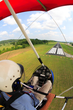 In-cockpit view of a man flying his Airborne Classic ultralight trike on final approach to the Marion County airport near Jasper
