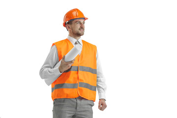 The builder in a construction vest and orange helmet standing on white studio background. Safety specialist, engineer, industry, architecture, manager, occupation, businessman, job concept