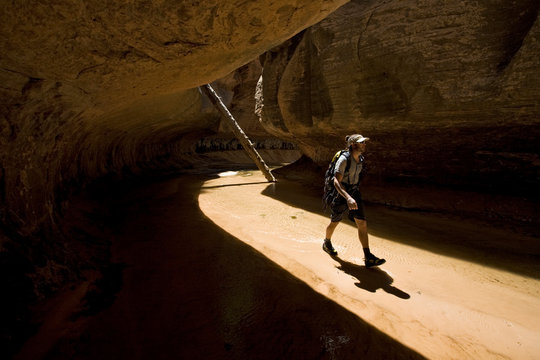 Eric Odenthal hiking through the narrows of the Left Fork of Great West Canyon, also know as The Subway, Zion National Park, Utah.