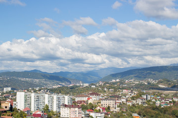 Fototapeta premium Panorama of the city by the mountains in summer