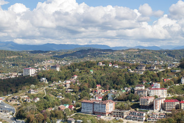 Fototapeta na wymiar Panorama of the city by the mountains in summer