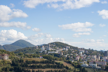 Panorama of the city by the mountains in summer