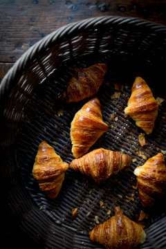 Fototapeta Mini croissants sit in a basket in France.