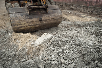 The street of the city is torn down. Construction and laying of pipelines and sewerage. Large excavator in construction. Chernivtsi, Ukraine, Europe, March 2019.