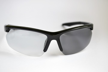 Testing sport sunglasses with photochromic effect, one of glasses was closed from the sun, and...