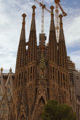 Barcelona, Spain-January 02, 2016: Amazing Church of the Holy Family surrounded by cranes. It is a large unfinished Roman Catholic church in Barcelona, designed by Catalan architect Antoni Gaudi