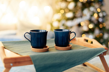 cups with tea on the background of the Christmas tree
