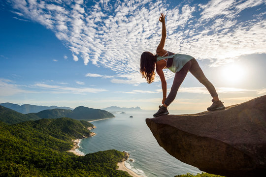 Woman standing on edge of rock