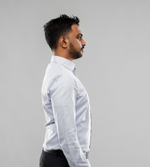 business, office worker and people concept - indian businessman side view over grey background