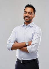 business, office worker and people concept - happy indian businessman in shirt over grey