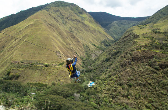 Woman riding on zipline through Amazon forest, Santa Teresa, Cusco region, Peru