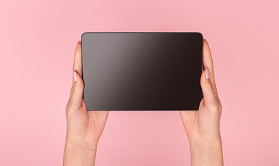 Crop hands with black tablet 