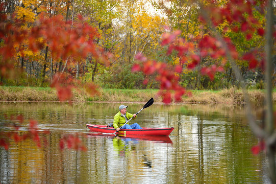 Man Kayaking On Lake