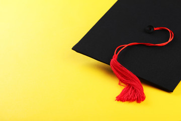 Graduation cap on yellow background