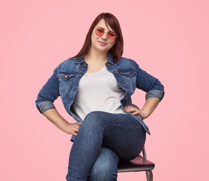 Confident plumpy girl in denim outfit 