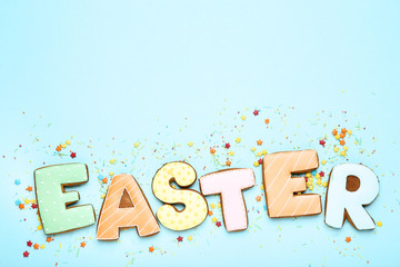 Word Easter by gingerbread cookies on blue background