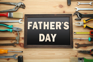 Inscription Fathers Day with different tools on brown wooden table