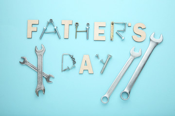 Inscription Fathers Day with tools on blue background