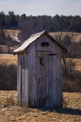 An outhouse in a farmers field