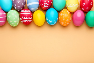 Fototapeta na wymiar Colorful easter eggs on beige background
