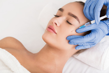 Beauty procedure. Woman receiving hyaluronic acid injection