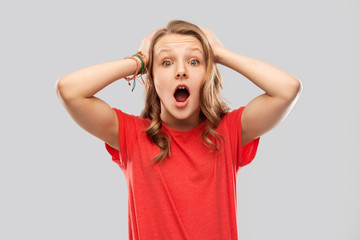 emotion, expression and people concept - impressed or shocked teenage girl with open mouth in red...