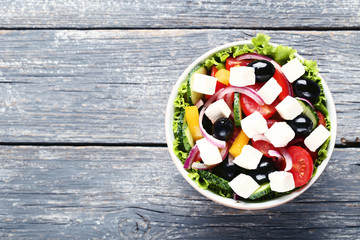 Vegetable salad in bowl on grey wooden table