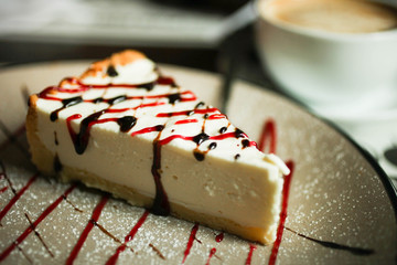 tasty cheesecake with  topping  and cup of coffee