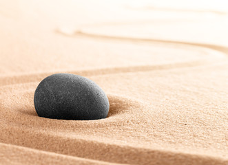 Fototapeta na wymiar Spa wellness or mindfulness stone and sand garden. Concentration or focus point for spiritual balance and purity of mind and soul. Sandy background with copy space. .