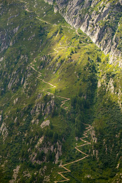 A steep mountain trail is winding up a slope above Chamonix in the French Alps.