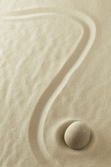 Fototapeta na wymiar mindfulness background with round stone and line in the sand. Minimalism for focus and concentration. Zen buddhu-ism or yoga concept.