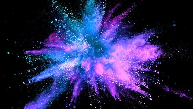 Super slowmotion shot of color powder explosion isolated on black background.