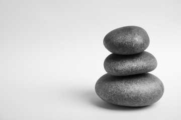 Stacked zen stones on white background. Space for text