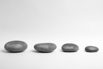 Fototapeta na wymiar Zen stones on white background. Space for text