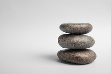 Fototapeta na wymiar Stacked zen stones on white background. Space for text