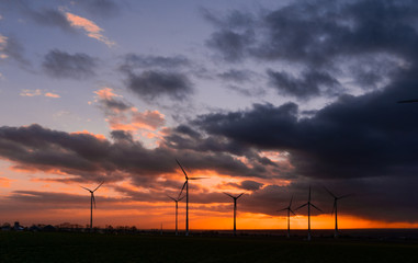 Fototapeta na wymiar Sunrise over wind turbines