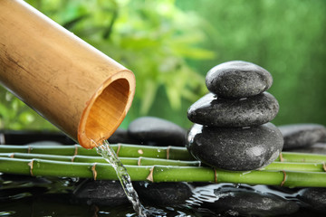 Traditional bamboo fountain with zen stones