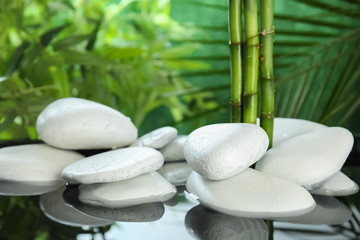Fototapeta na wymiar White zen stones in water on blurred background