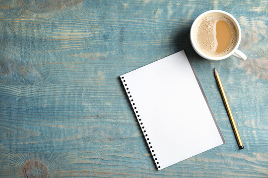 Notebook and coffee on wooden background, top view with space for text - Powered by Adobe