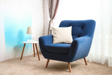 Modern interior of stylish room with cozy armchair