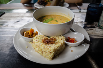 Delicious rice and a bowl of soup with spicy sauce make this lunch very tasty and delicious. It is organic and healthy too