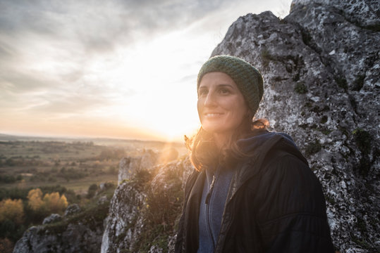 Portrait of woman against rock formation, Polish Jura, Rzedkowice, Silesia, Poland